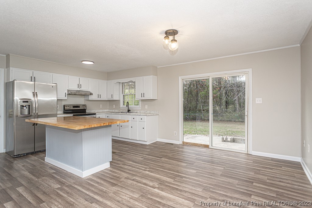 2179 Shaw Rd Extension Fayetteville, NC 28311 - Photo 8 of 42 a kitchen with stainless steel appliances granite countertop a stove a refrigerator and a sink with wooden floor