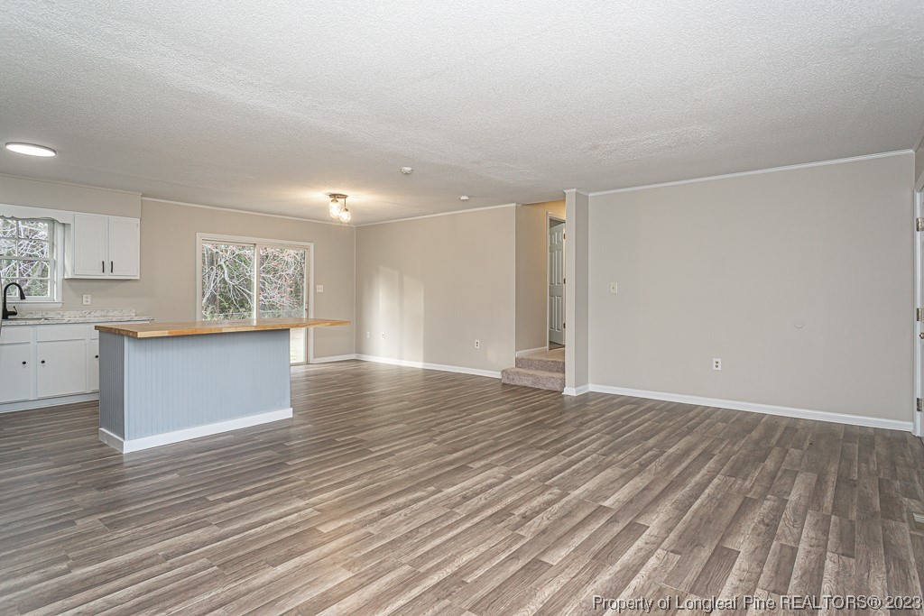 2179 Shaw Rd Extension Fayetteville, NC 28311 - Photo 9 of 42 a view of an empty room with wooden floor and a window