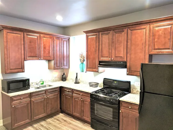 a kitchen with a stove a sink and a refrigerator