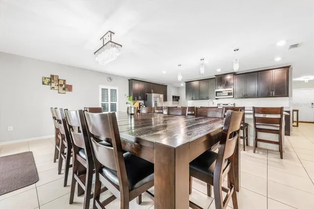 a view of kitchen with cabinets table and chairs