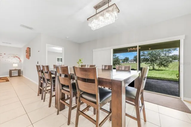 a dining room with furniture a chandelier and fireplace