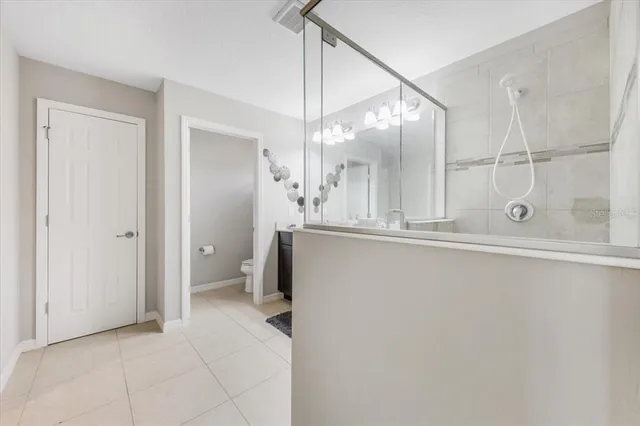 an empty room with a bathroom and mirror