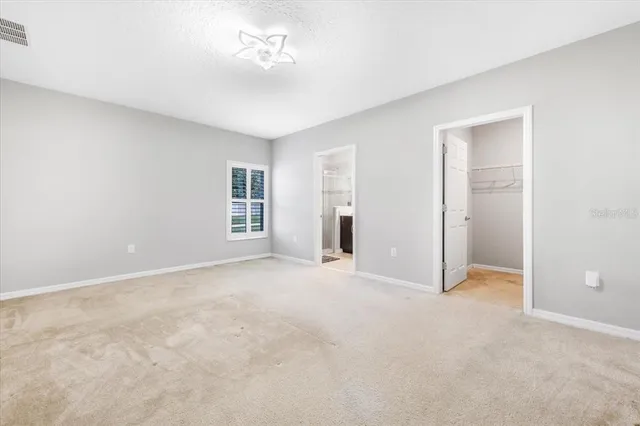 a view of an empty room with a bathroom