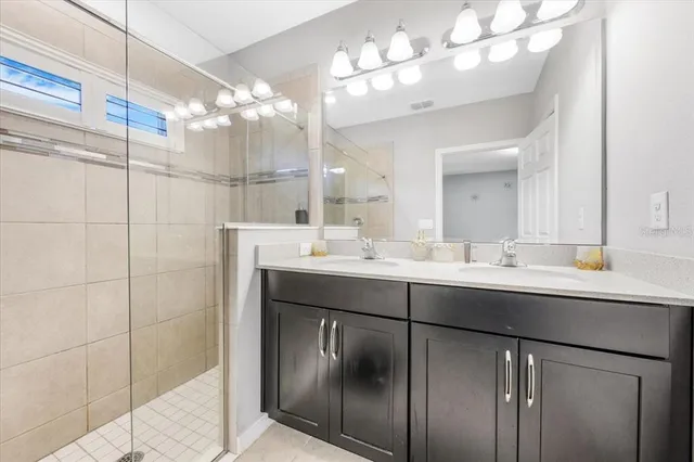 a bathroom with a sink vanity and a mirror