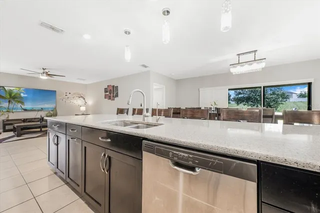 a kitchen with stainless steel appliances granite countertop a sink and dishwasher with wooden floor