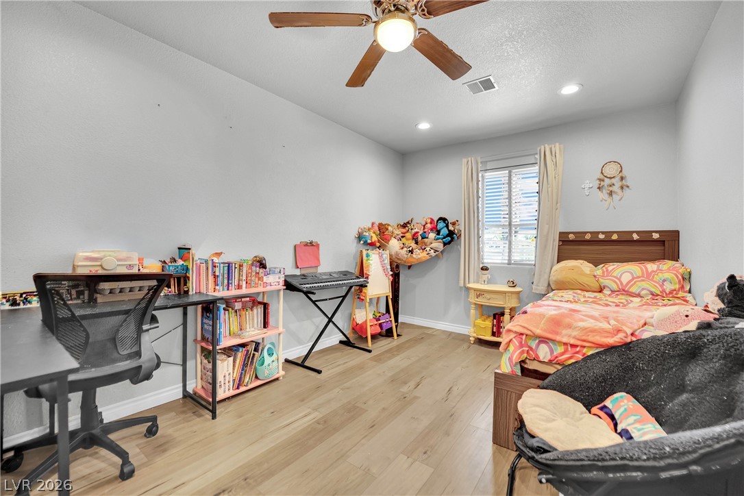 420 North Racetrack Road Henderson, NV 89015 - Photo 26 of 52 This spacious room features light wood flooring, offering a comfortable and adaptable living environment.
