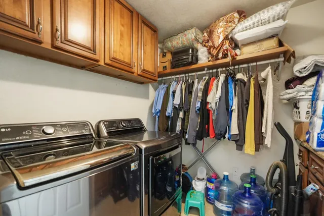 a view of walk in closet with clothes