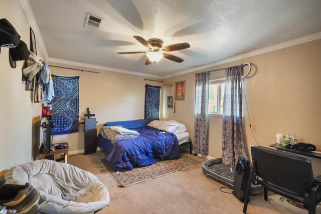 a bedroom with furniture and a window