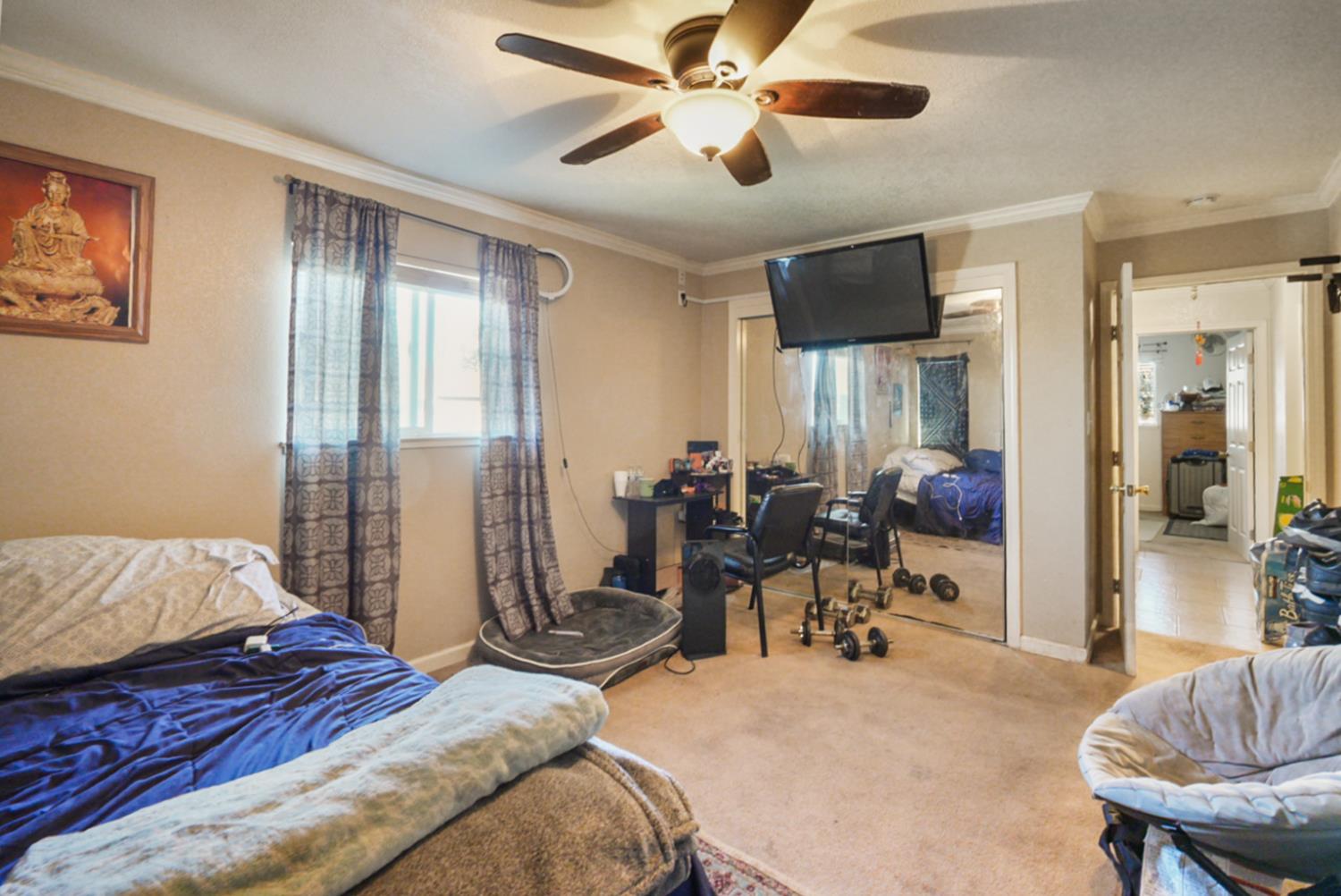 561 Church Street Modesto, CA 95357 - Photo 17 of 38 a bedroom with a bed and wooden floor