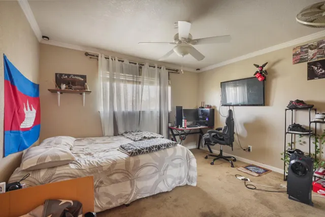 a bedroom with a bed a desk and chair