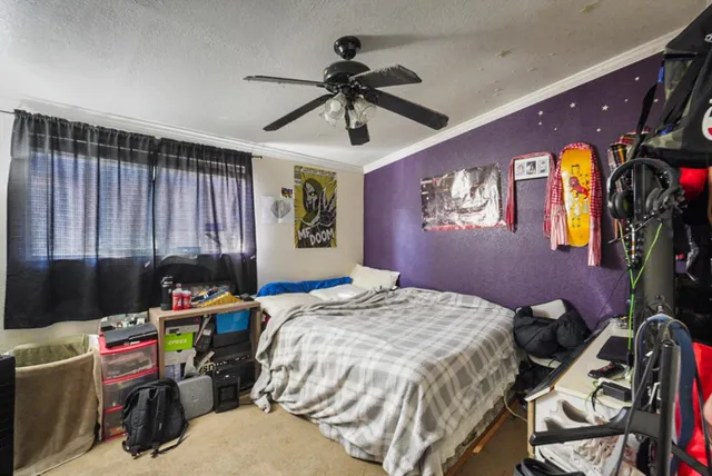 a bed room with a bed and a window