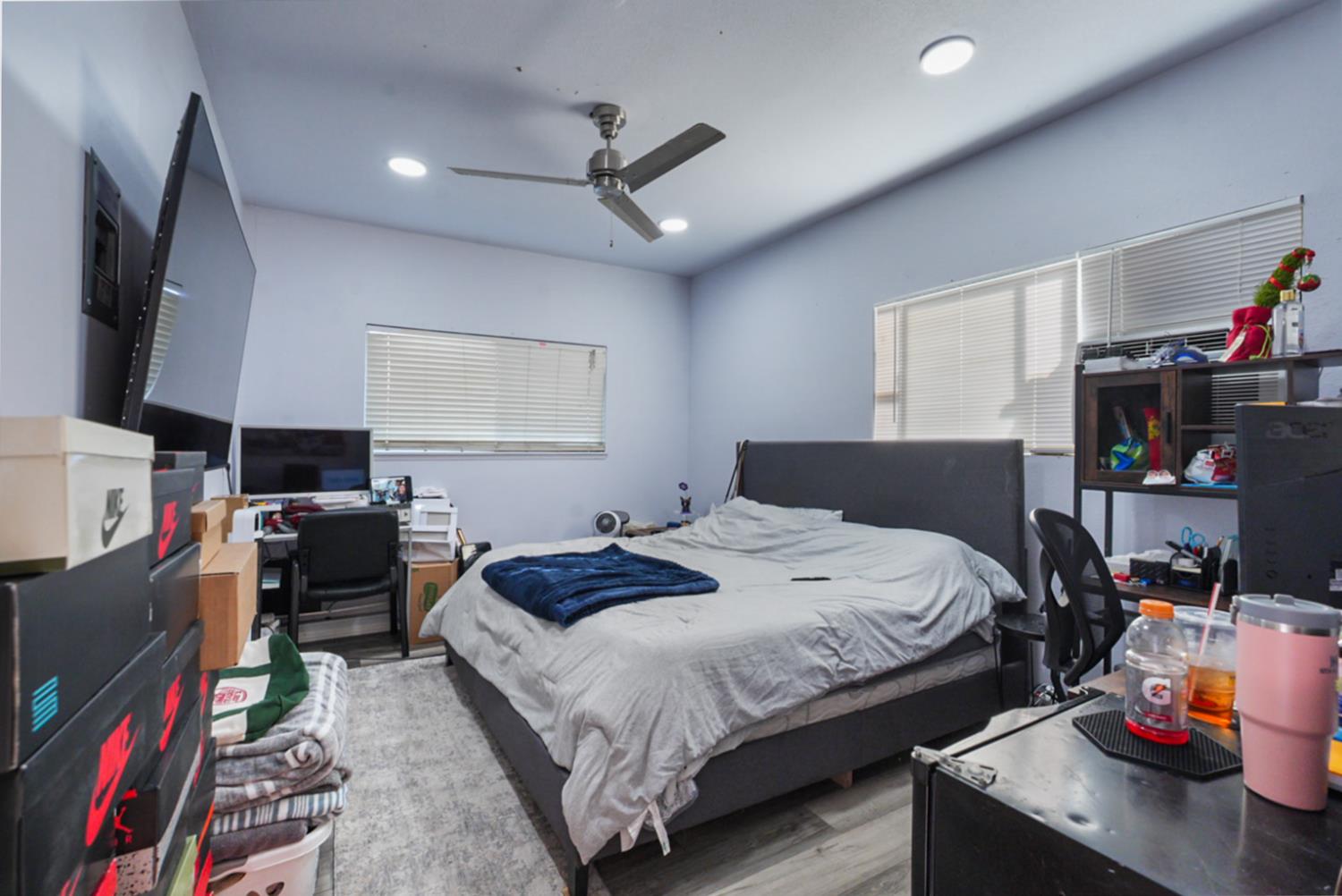 561 Church Street Modesto, CA 95357 - Photo 25 of 38 a bedroom with a bed a dresser and a flat screen tv