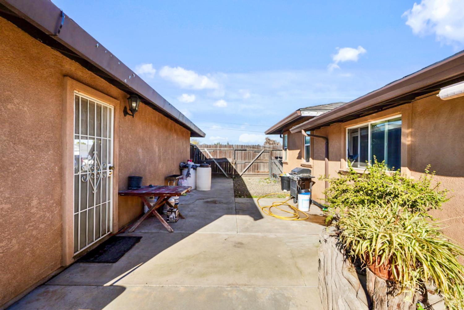 561 Church Street Modesto, CA 95357 - Photo 26 of 38 a view of a patio with table and chairs with wooden floor and fence