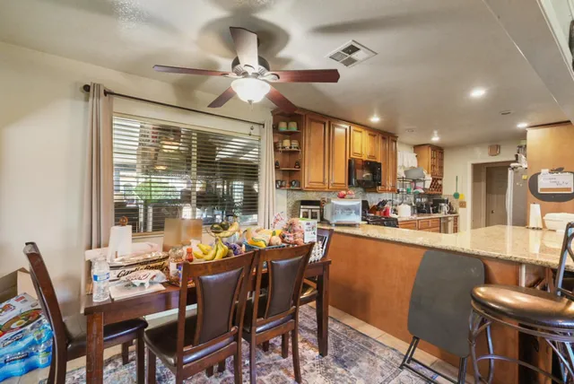 a dining room with furniture a chandelier and wooden floor
