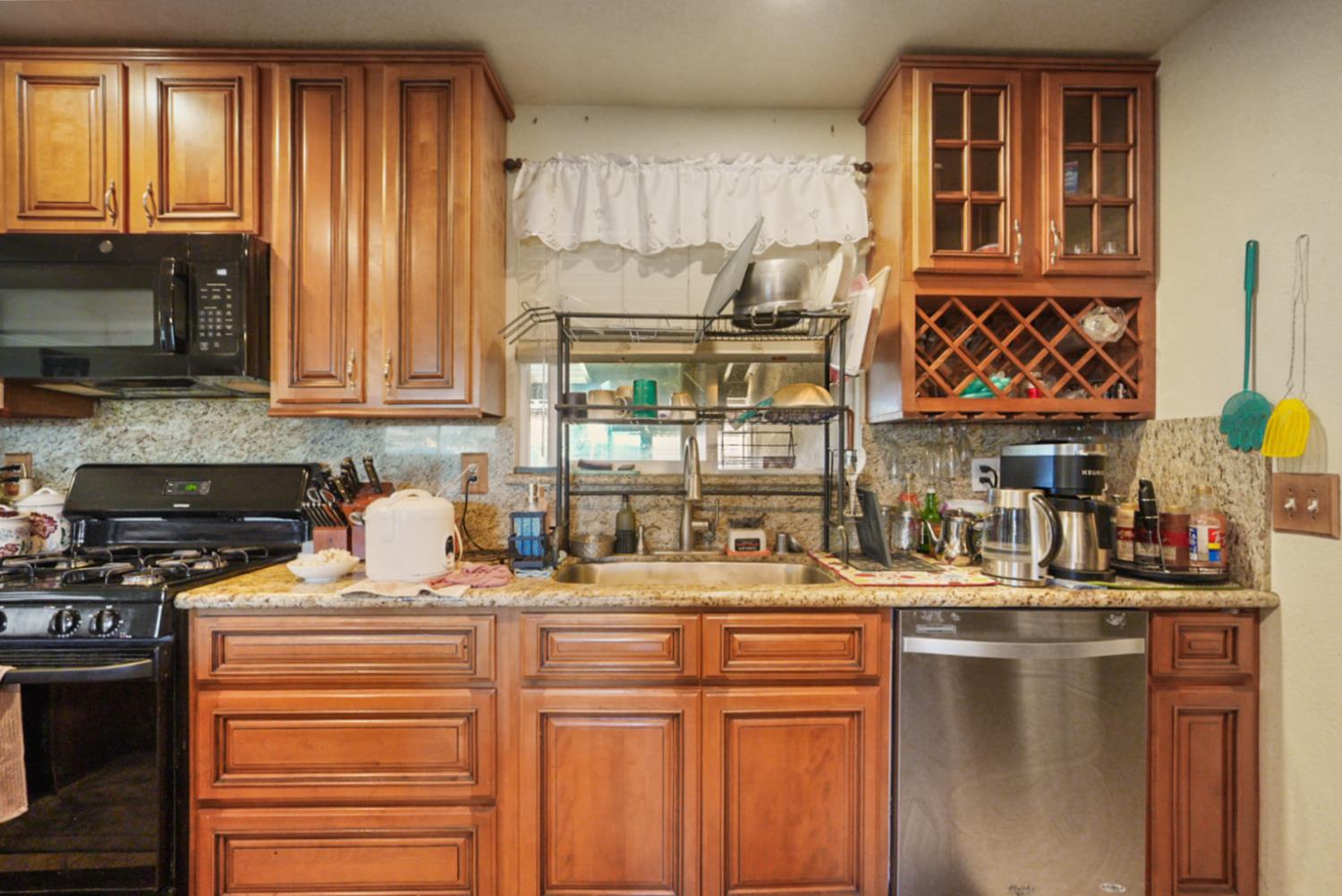561 Church Street Modesto, CA 95357 - Photo 10 of 38 a kitchen with stainless steel appliances granite countertop a sink stove and cabinets