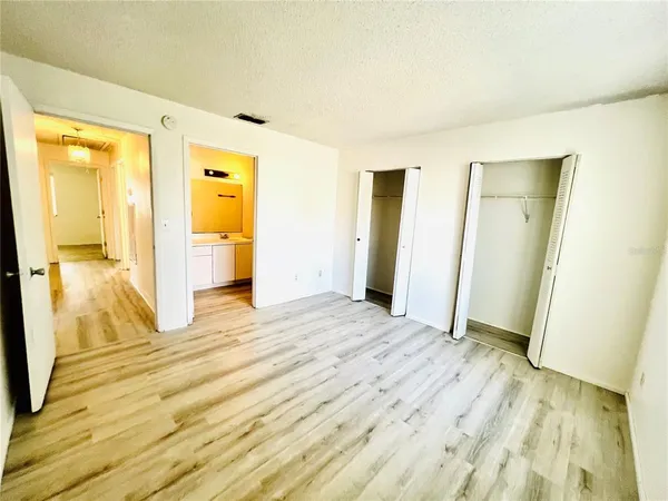 a view of a room with wooden floor and a bathroom