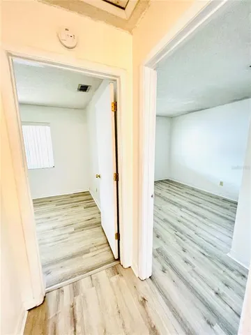 a view of a room with wooden floor and staircase
