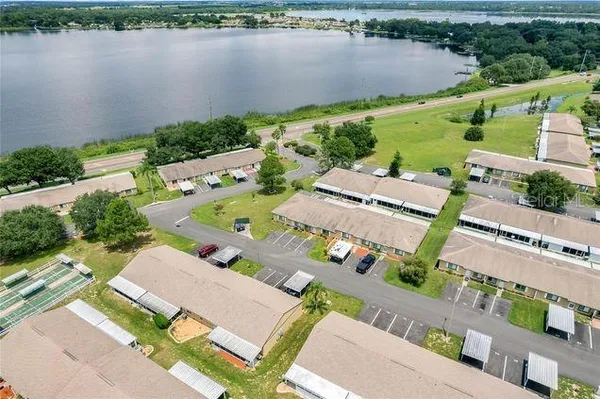 an aerial view of a house with outdoor space and lake view