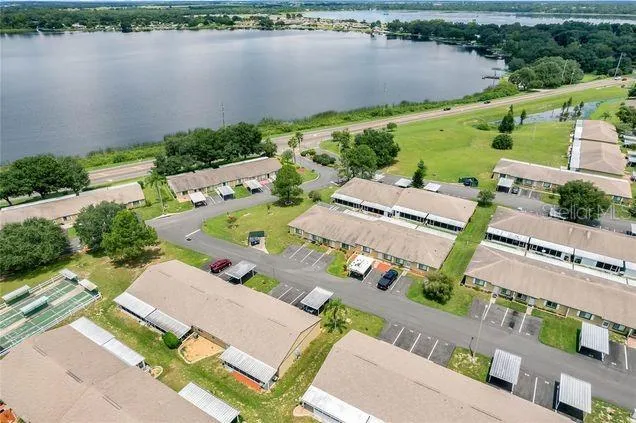 an aerial view of a house with outdoor space and lake view