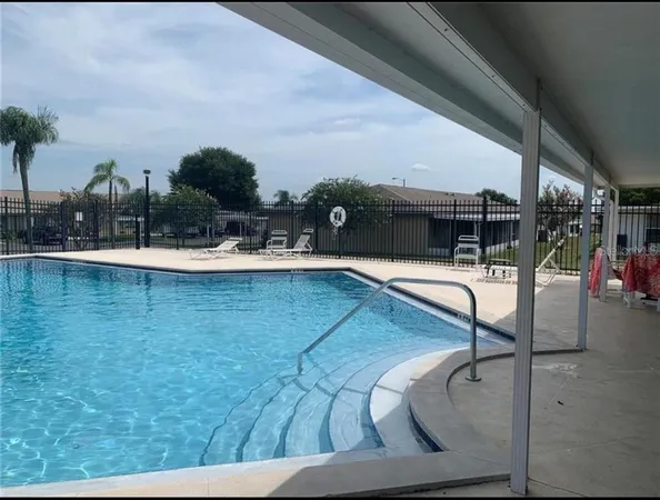 a swimming pool with chairs