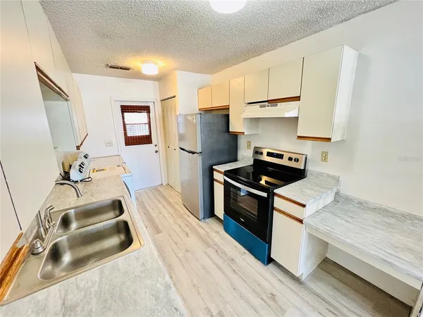 a kitchen with wooden cabinets and a stove top oven