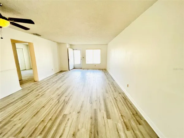 a view of a room with wooden floor and a balcony