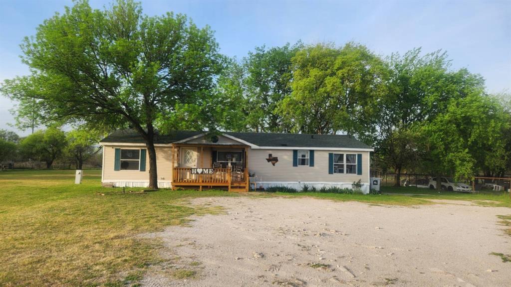7241 South Interstate 45 Service Road Alma, TX 75119 - Photo 11 of 11 Manufactured / mobile home with a wooden deck, a front yard, and driveway