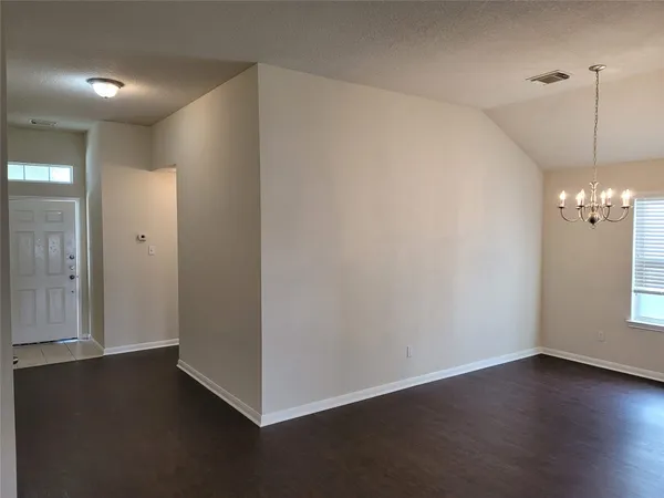 a view of a room with wooden floor and window