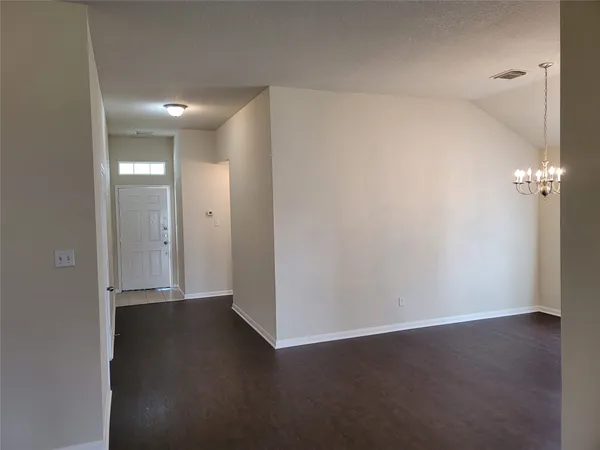 an empty room with wooden floor