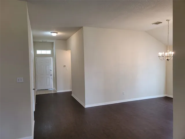 an empty room with wooden floor