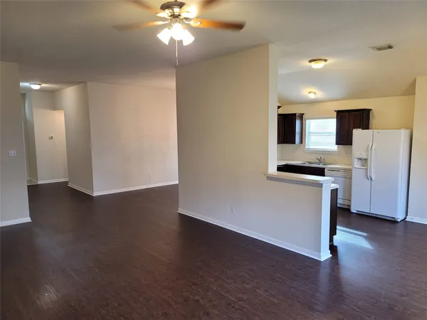 a view of kitchen with wooden floor and electronic appliances