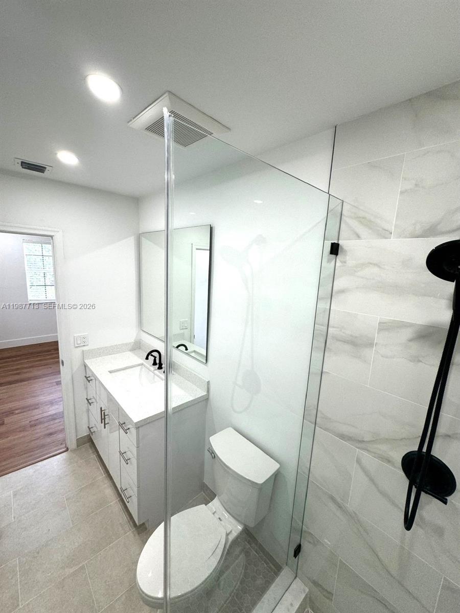 3619 South Le Jeune Road, Unit 1 Coral Gables, FL 33134 - Photo 11 of 17 a bathroom with a double vanity sink toilet and shower