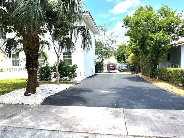 a view of a street with a tree on the side of the road