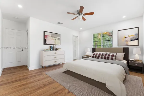 a bedroom with a large bed and a window