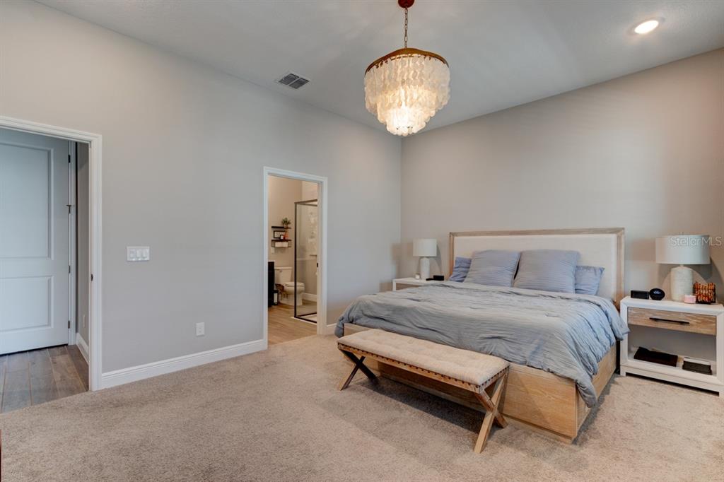 828 MIDDLETON Street DeBary, FL 32713 - Photo 12 of 20 a spacious bedroom with a bed and a chandelier