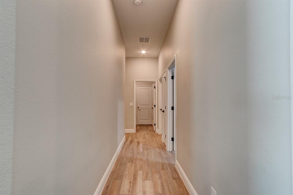 828 MIDDLETON Street DeBary, FL 32713 - Photo 14 of 20 a view of a hallway with wooden floor and a hallway
