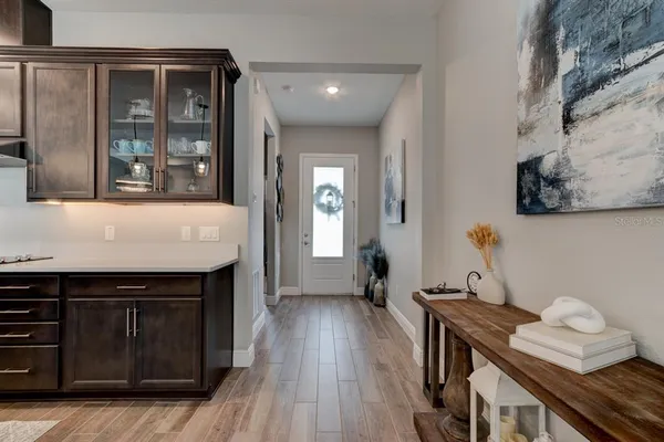 a kitchen with a stove and wooden floor