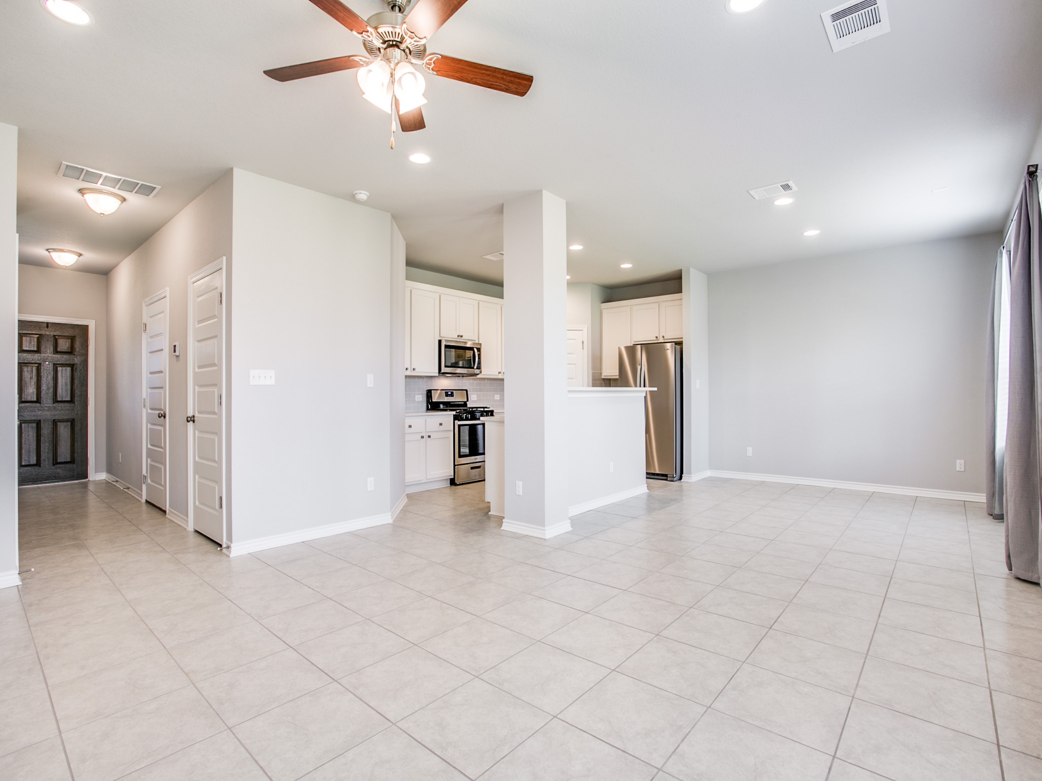 508 Rearing Mare Pass Georgetown, TX 78626 - Photo 6 of 26 Family room with ceiling fan, recessed lighting, light tile patterned floors, and baseboards