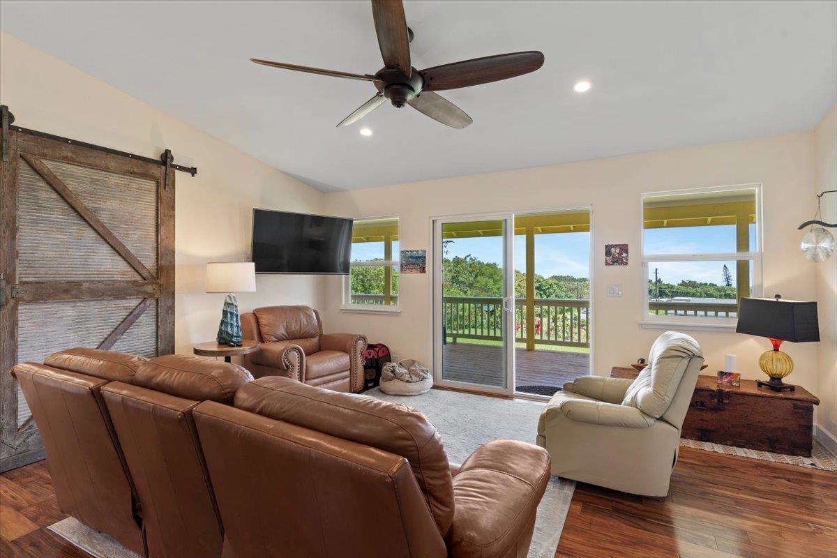 139 Pauwela Road Haiku, HI 96708 - Photo 12 of 42 a living room with furniture a flat screen tv and a large window