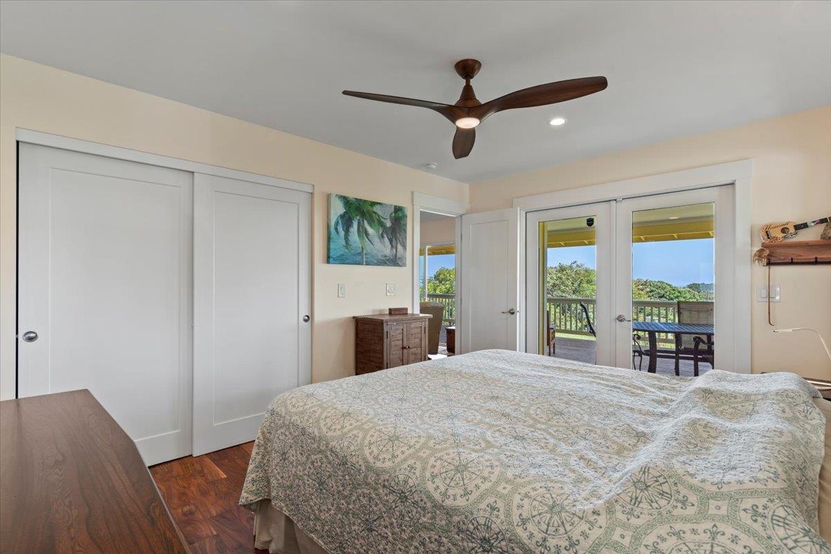 139 Pauwela Road Haiku, HI 96708 - Photo 17 of 42 a bedroom with a large bed and a large window