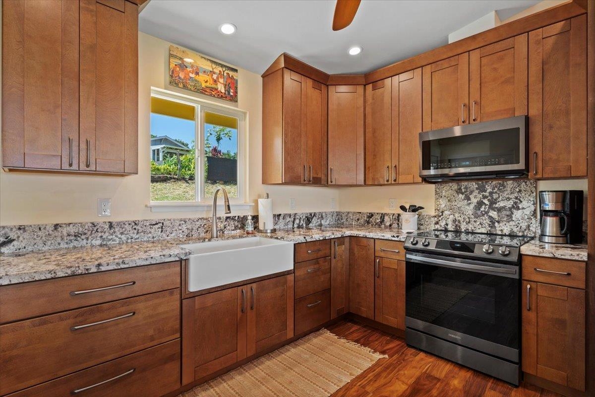 139 Pauwela Road Haiku, HI 96708 - Photo 6 of 42 a kitchen with stainless steel appliances kitchen island granite countertop a sink stove and microwave