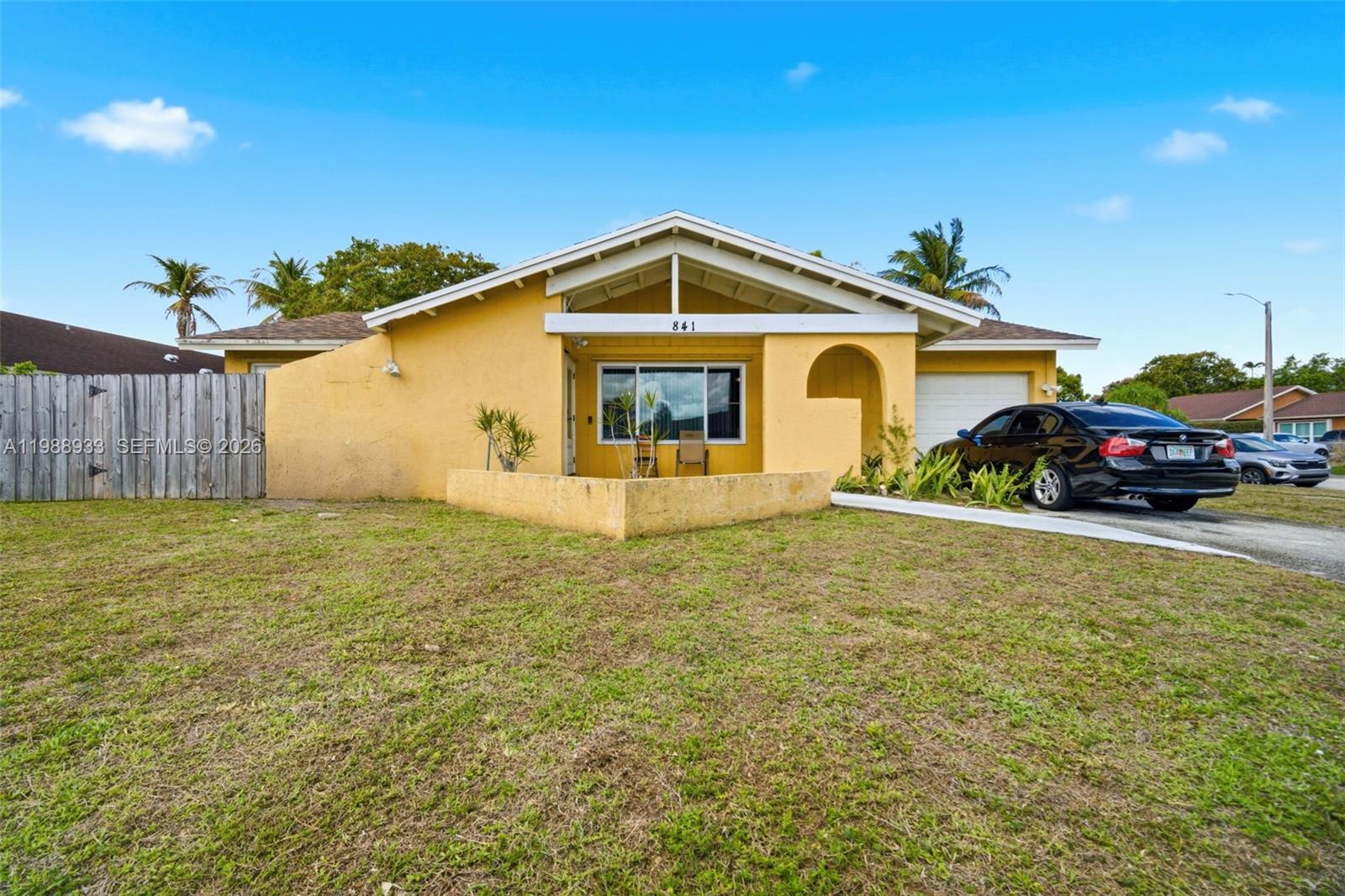 841 Southwest 55th Avenue Margate, FL 33068 - Photo 1 of 26 a front view of a house with garden