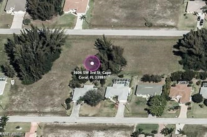 3606 Southwest 3rd Street Cape Coral, FL 33991 - Photo 2 of 3 an aerial view of a house with a yard and large tree