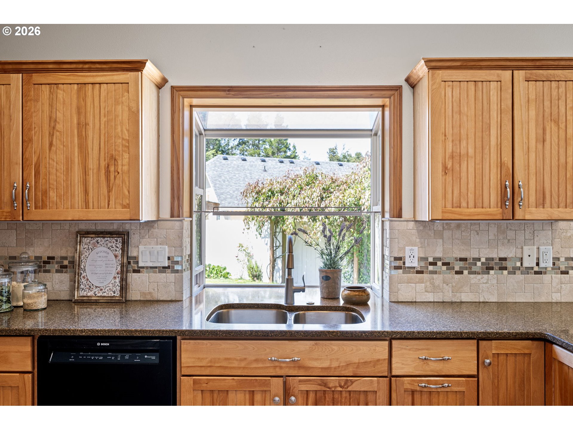 2218 Willow Loop Florence, OR 97439 - Photo 32 of 47 a kitchen with a window a sink and cabinets