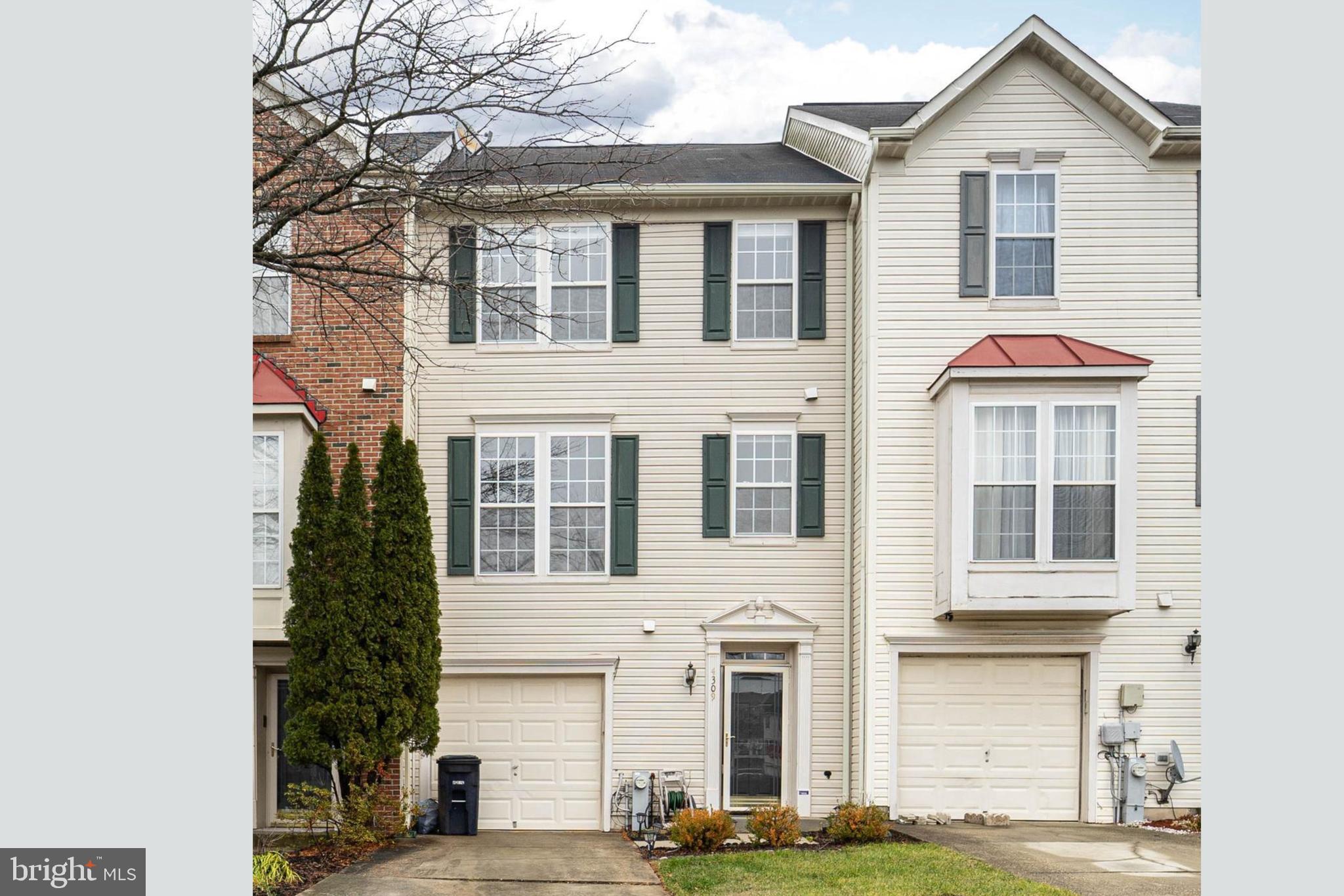 a front view of a residential houses with yard