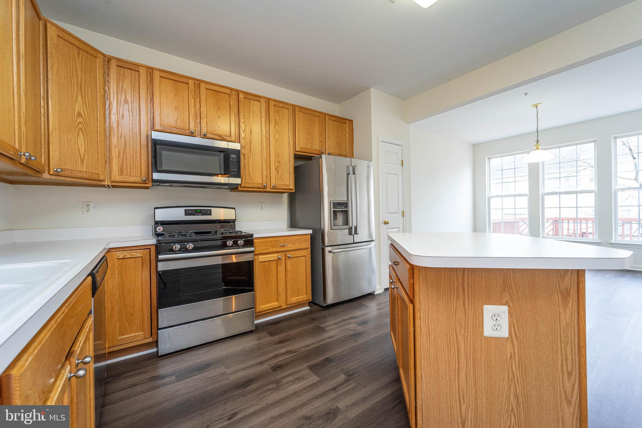 4309 Windflower Way Bowie, MD 20720 - Photo 14 of 46 a kitchen with stainless steel appliances a stove a sink and a refrigerator