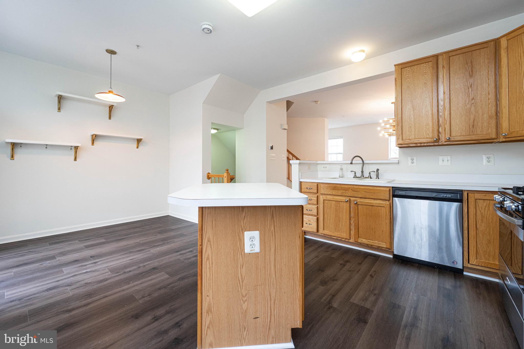 4309 Windflower Way Bowie, MD 20720 - Photo 17 of 46 a kitchen with a sink cabinets and wooden floor