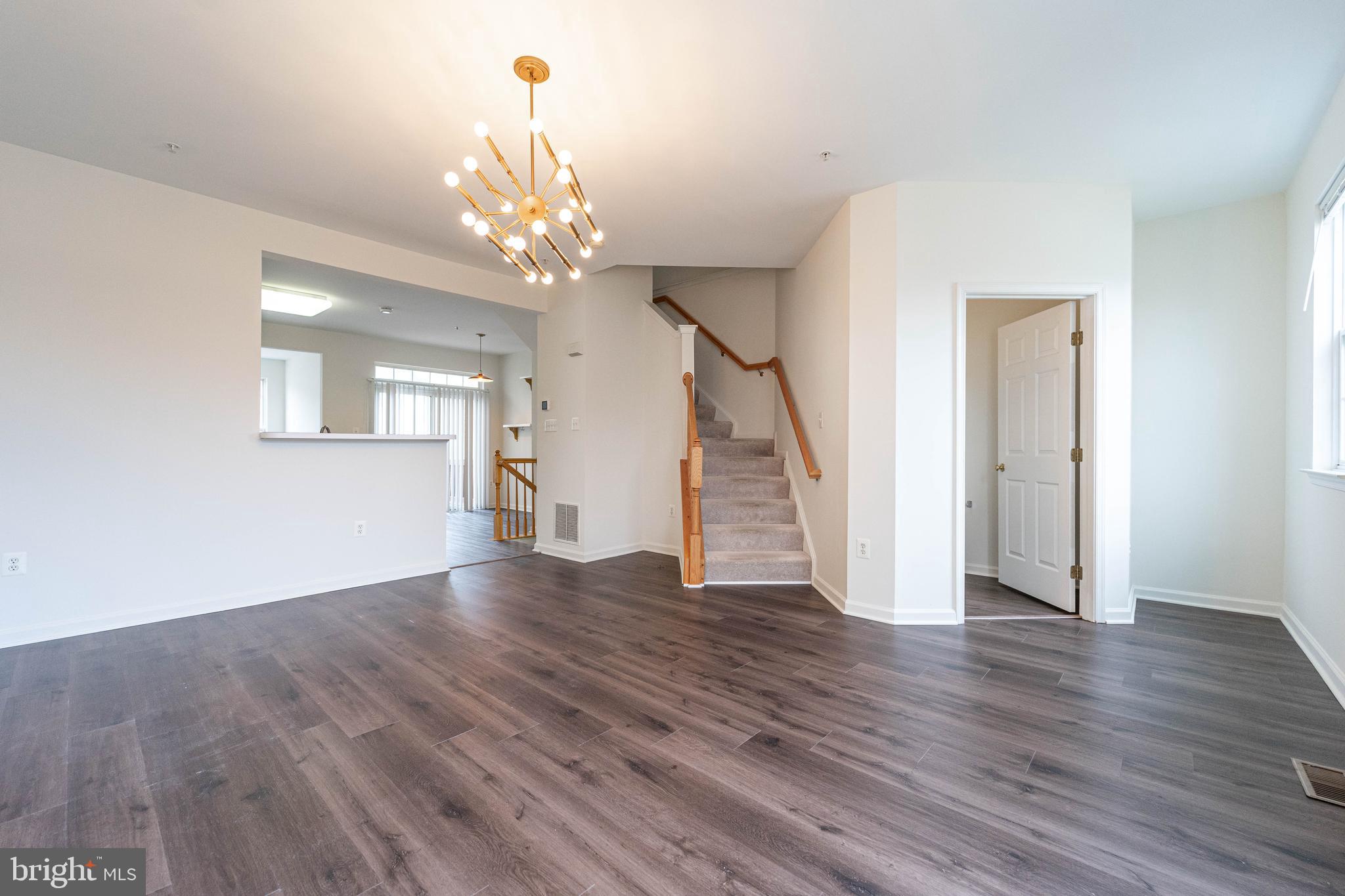 4309 Windflower Way Bowie, MD 20720 - Photo 19 of 46 a view of an empty room with wooden floor and a window