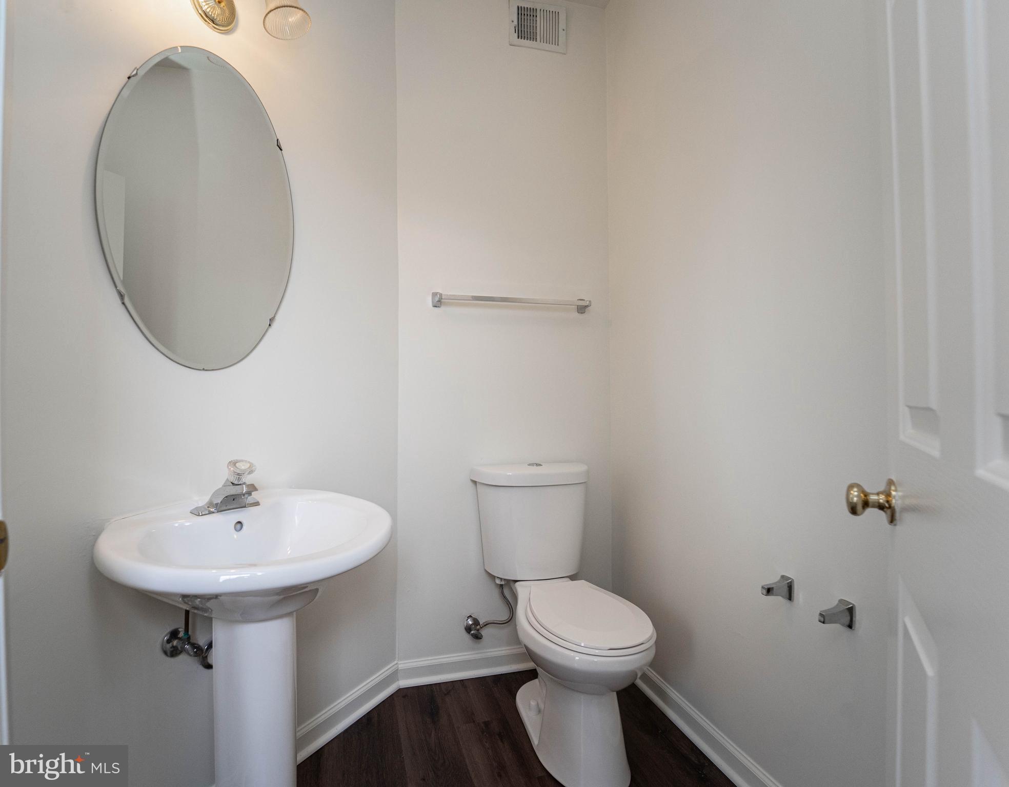 4309 Windflower Way Bowie, MD 20720 - Photo 20 of 46 a bathroom with a sink toilet and a mirror