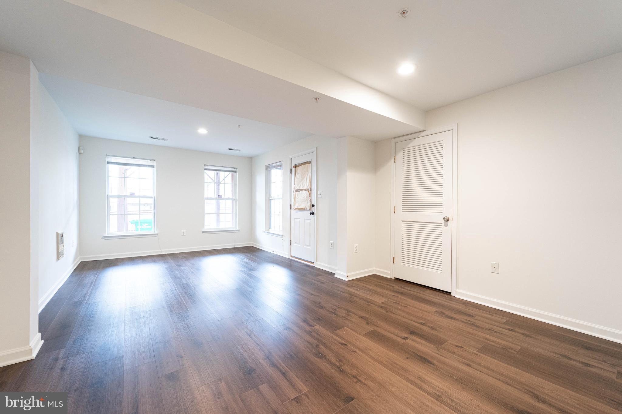 4309 Windflower Way Bowie, MD 20720 - Photo 2 of 46 an empty room with wooden floor and windows